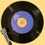 Teenbeat metal 7-inch 45 adaptor, back, with Teenbeat 69 on a phonograph